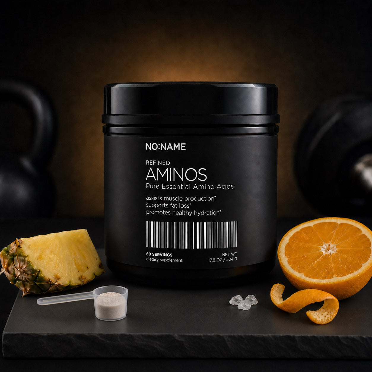 NO NAME Essential Aminos and Electrolytes with pineapple, orange, mineral electrolytes and serving scoop on black slate